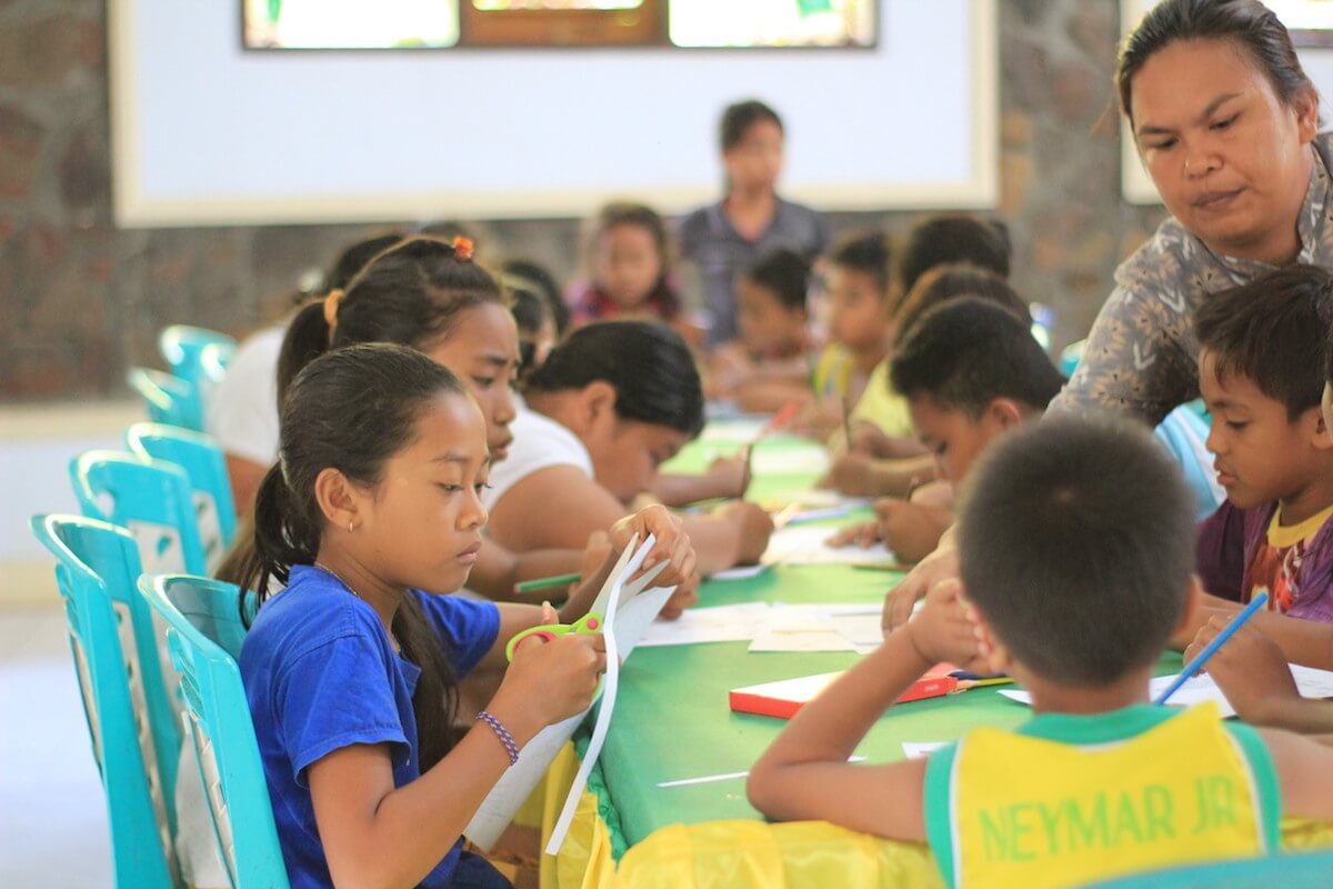 Helen working with village school children Helen working with village school children