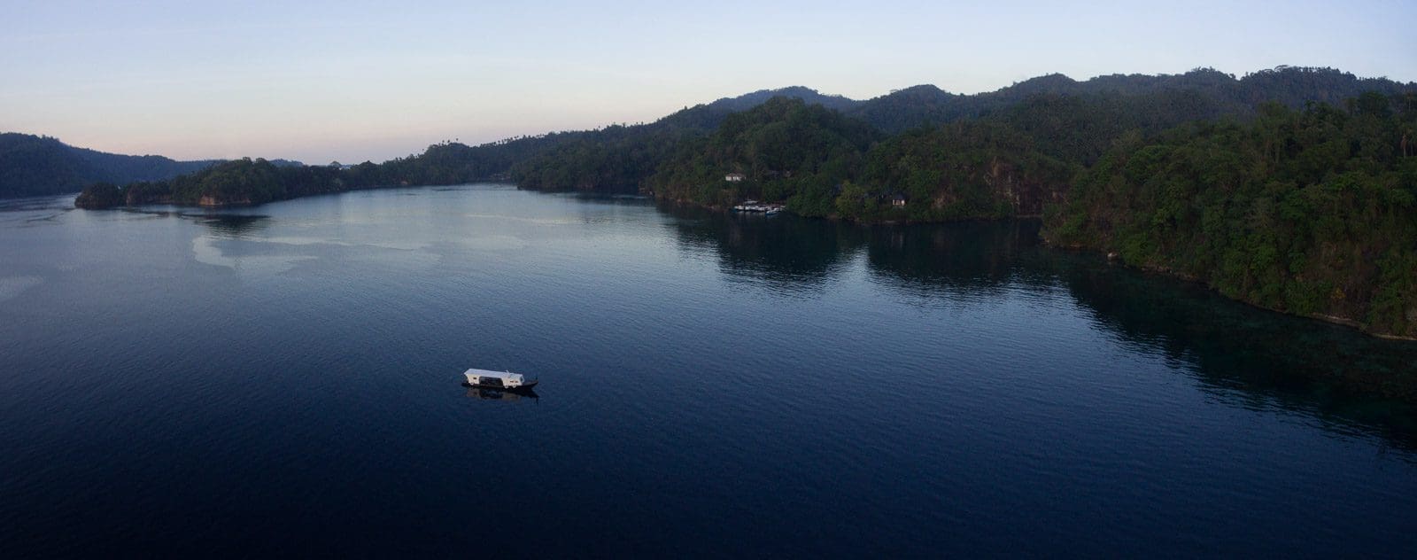 Cruising the calm waters of Lembeh Strait at dusk